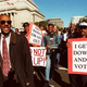 Downocratic supporters march through the streets of Chocolate
City.